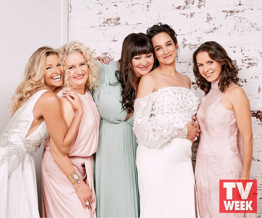 Cast members of Wentworth at the Logies 2018, dressed elegantly, smiling against a brick wall backdrop.