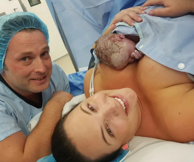 Mother, father and baby immediately after caesarean delivery