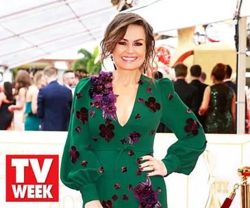 Lisa Wilkinson at a TV event, wearing a green dress with floral embellishments.