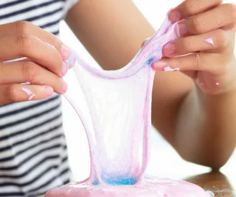 Could slime be harming your kids? Child's hands stretching slime
