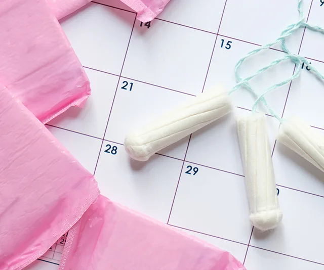 Period products on a calendar indicating menstrual tracking.