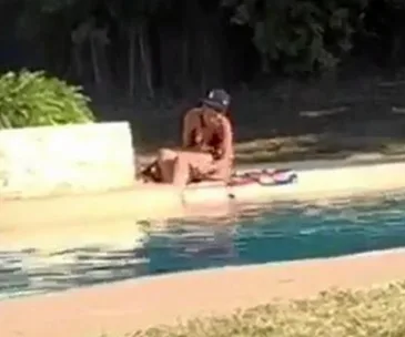 Woman shaving legs in public pool 