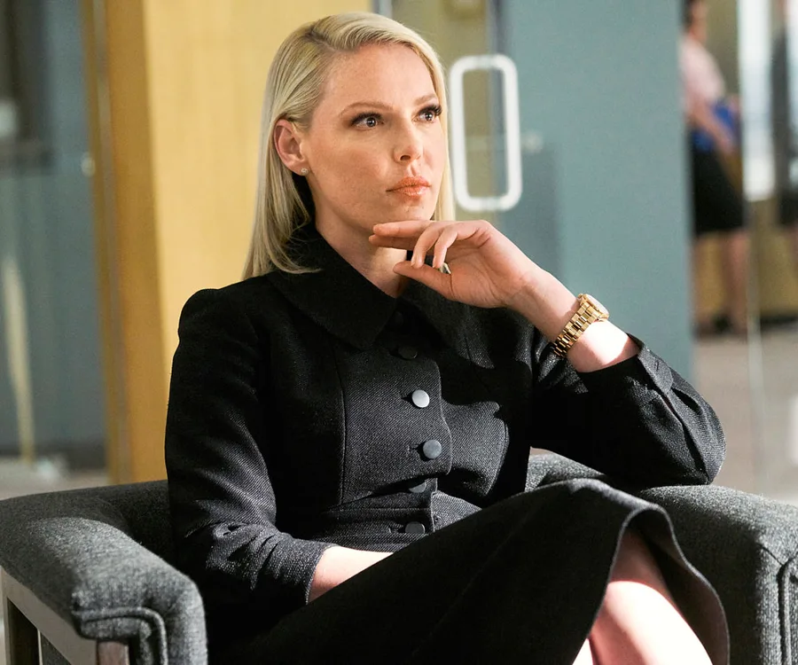Katherine Heigl as Samantha Wheeler in a thoughtful pose from Suits Season 8, wearing a black outfit and gold watch.