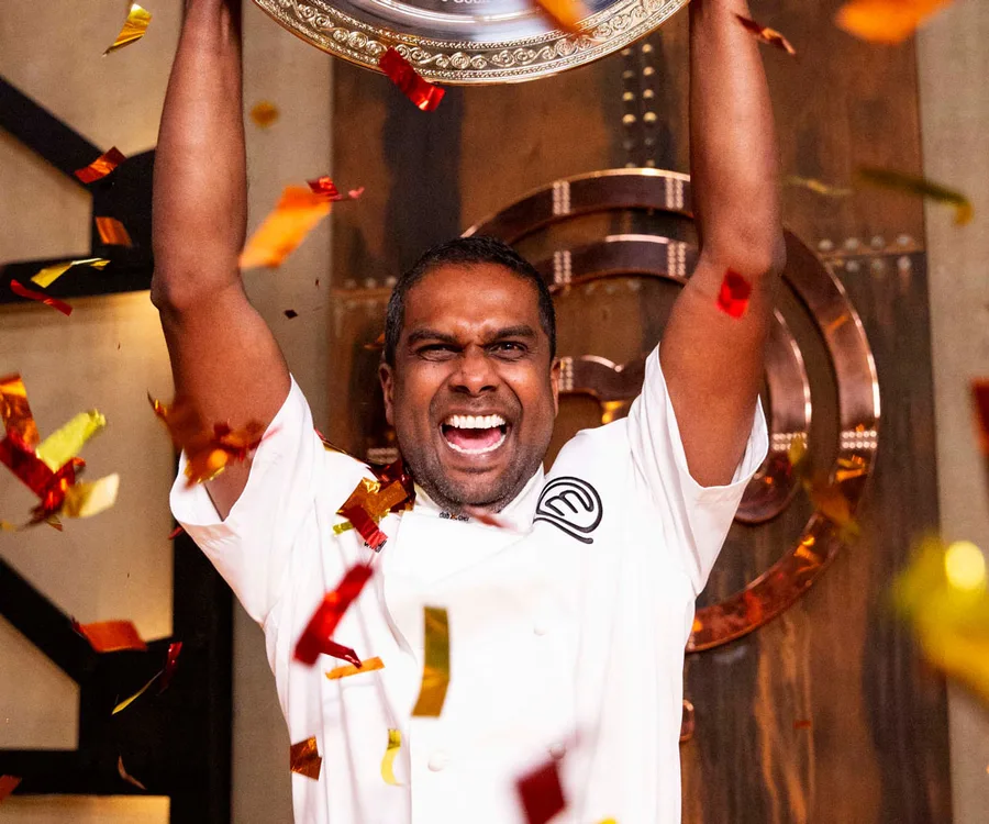 Winner of MasterChef Australia 2018 celebrates with trophy, surrounded by confetti.