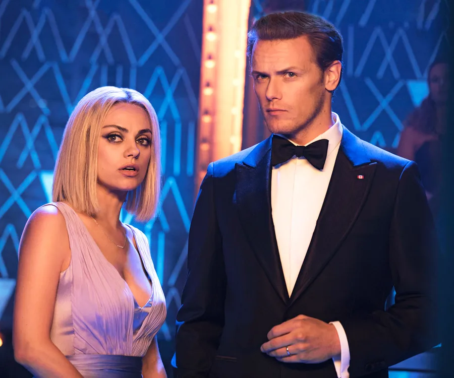 Mila Kunis and Sam Heughan in elegant attire, scene from "The Spy Who Dumped Me".