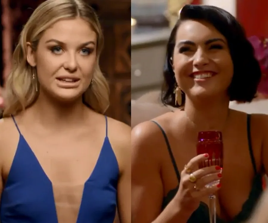 Two women from The Bachelor Australia in blue dresses, one speaking and the other smiling while holding a glass.