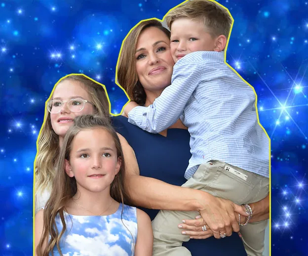 Four people smiling against a starry blue background, with one person holding a child.