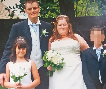 Wedding photo of a couple with a bouquet, a young girl and a boy with a pixelated face, outdoors.