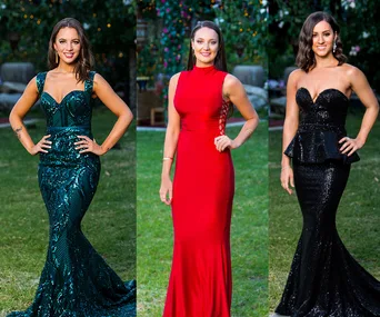 Three women in elegant evening gowns, one in green, one in red, and one in black, standing on a grassy outdoor setting.