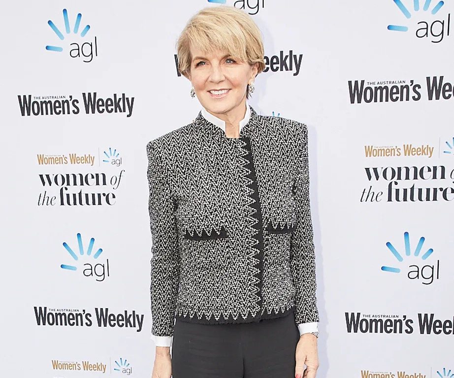 "Person in a patterned blazer on a red carpet at the Australian Women's Weekly event backdrop."