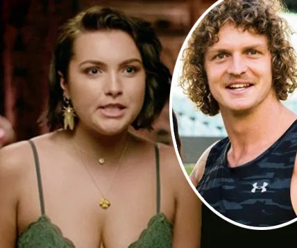 A woman in a green top speaks, with an inset of a smiling man in a black tank top beside her.