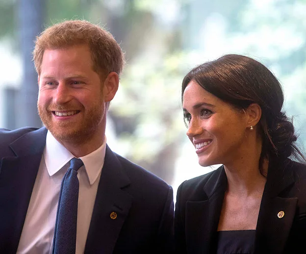 Prince Harry and Meghan Markle smiling during their Australia tour.
