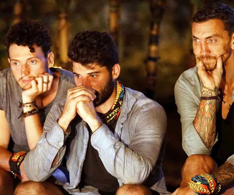 Three contestants sitting pensively at Tribal Council during Australian Survivor 2018.