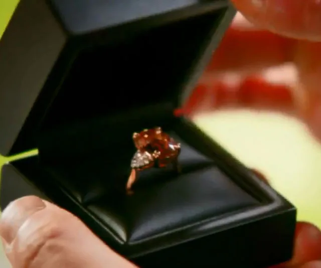 Gold engagement ring with a large oval stone and diamonds in a black box, from "The Bachelor Australia 2018".