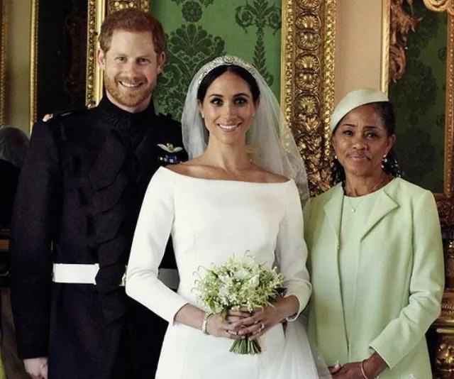 Royal wedding photo: Bride with tiara, groom in military attire, and woman in pastel attire, in ornate room.