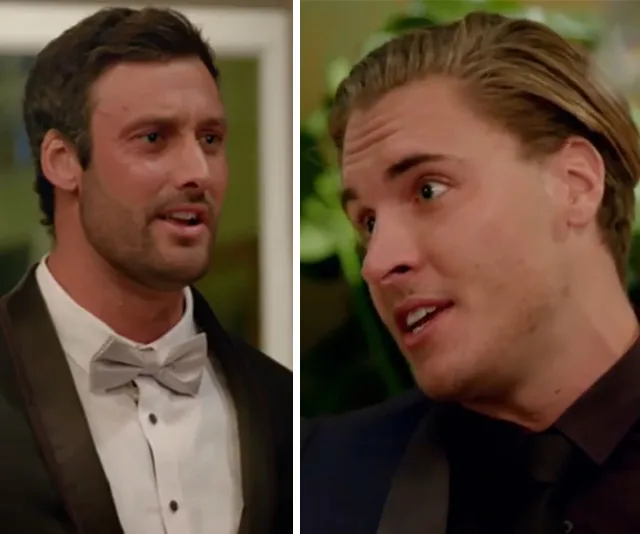 Two men in formal wear having a conversation, one in a bow tie, the other with slicked-back hair.