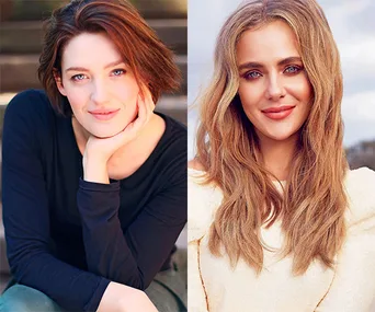 Two women smiling, one with short dark hair wearing black, the other with long blonde hair wearing a light top.