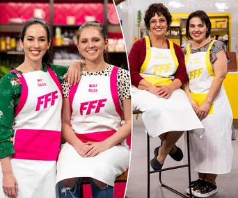 Two teams from "Family Food Fight" 2018 in kitchen attire, smiling and posing for the camera.