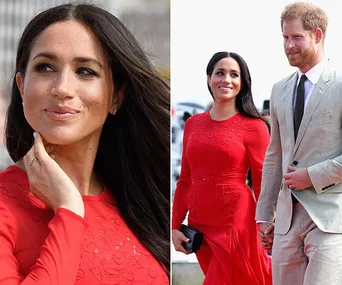 Pregnant Meghan Markle in a red dress, holding hands with Prince Harry at an outdoor event.