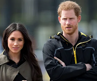 Don't know who they are; they stand outdoors, one wearing a jacket with an Invictus Games logo, the other in a coat.