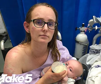Woman with a bruised face in a hospital, feeding a baby from a bottle, sitting by medical equipment; "Take 5" logo visible.