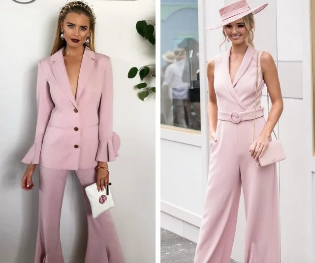 Two women in stylish pink outfits; one in a tailored suit and the other in a chic jumpsuit with a matching hat.