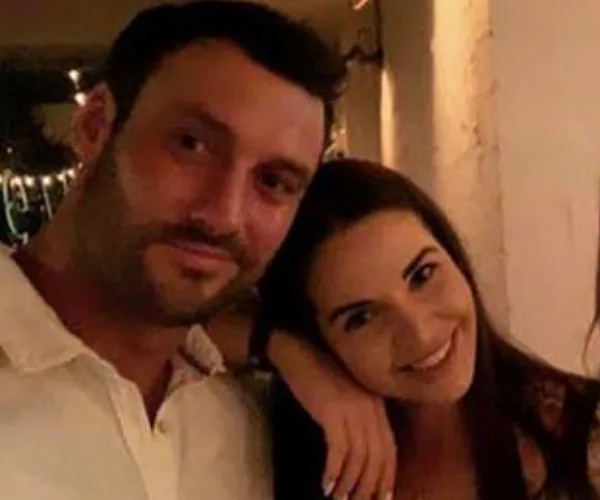 Two people smiling and posing closely together at an event or gathering.