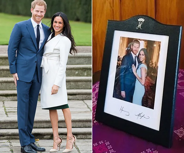 Framed photo of a couple posing together, standing on stone steps, and signed by both.