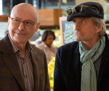 Alan Arkin and Michael Douglas in a scene from "The Kominsky Method," standing together indoors.