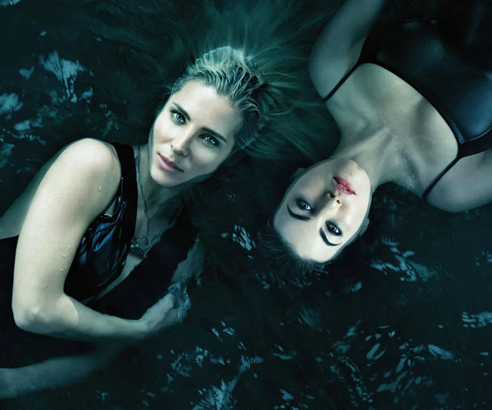 Two women in dark swimsuits floating in water, facing the camera, from the series "Tidelands."