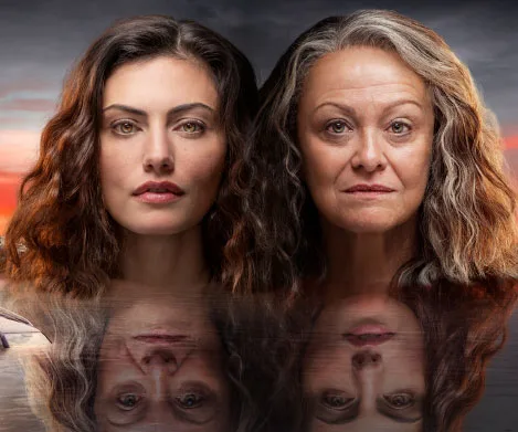Two women with long hair, one younger and one older, are reflected on the water with a sunset backdrop.