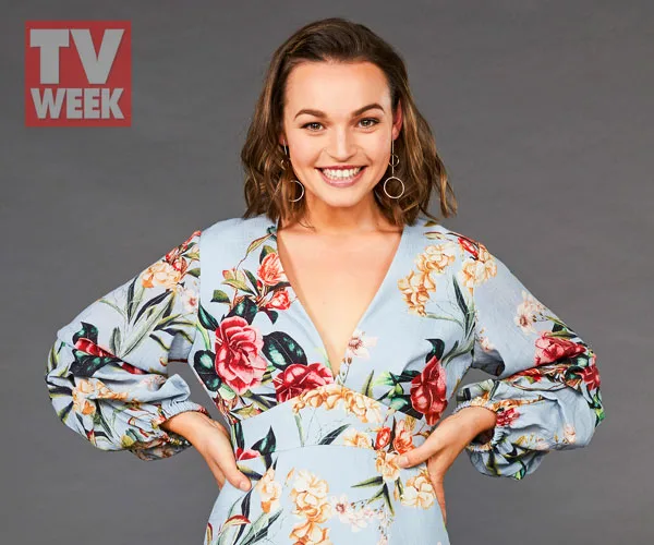 A woman in a floral dress smiling, with "TV Week" logo in the corner.