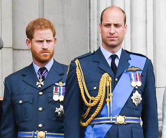 Two men in formal military uniforms, standing side by side, looking forward.