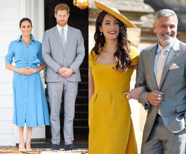 Two couples in formal attire; one in blue and gray and the other in yellow and gray, standing outdoors and smiling.