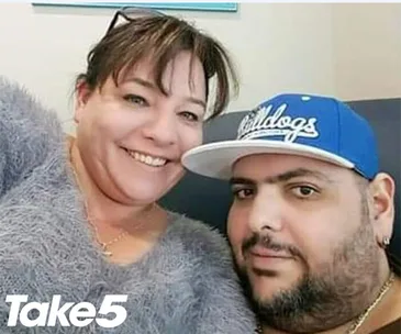 Two people smiling, sitting together on a couch. One wears a blue cap with "Bulldogs" text. "Take 5" logo in the corner.