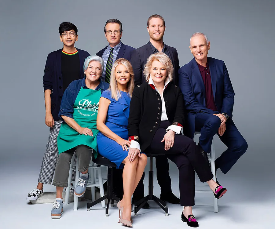 The cast of the "Murphy Brown" revival, including an older woman in a black blazer, posing in a studio setting.