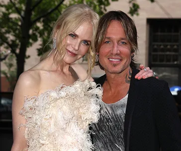 Two people posing together, smiling, outdoors during the 2018 ARIA event.