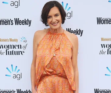 Woman in an orange dress at the "Women of the Future" event by Australian Women's Weekly.