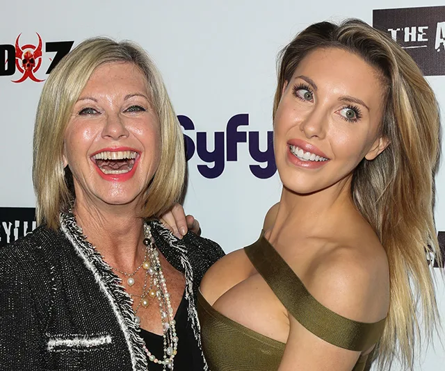 Two women smiling and posing together at a Syfy event.
