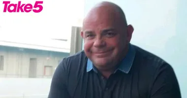 A man in a dark shirt smiles at the camera; "Take 5" logo in the top left corner.