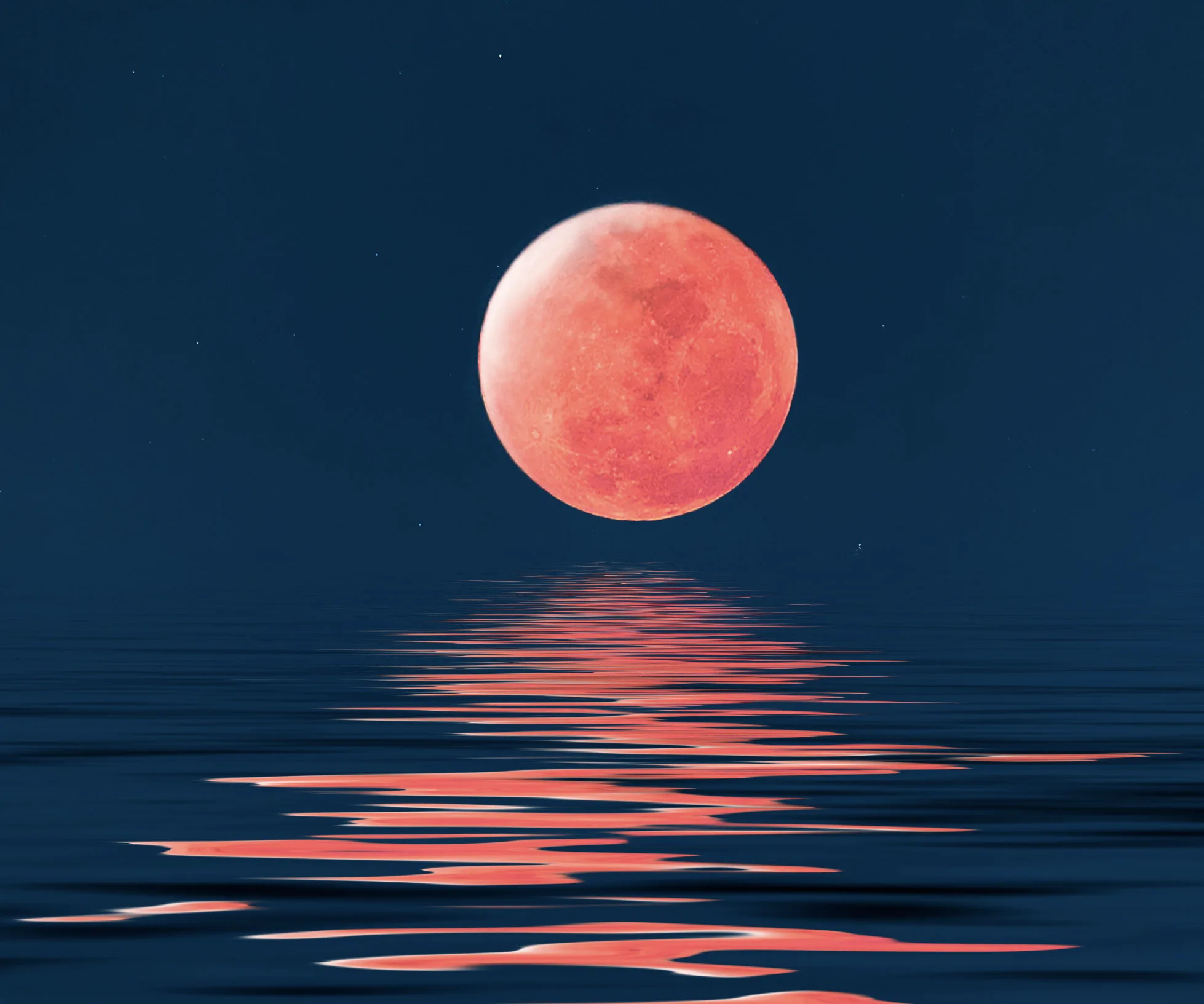 Red moon reflecting on water against a dark blue sky.