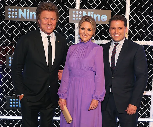 Three individuals standing together at a Nine Network event, with a netted backdrop displaying the logo.