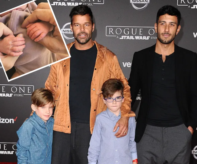 "Two adults with two children at 'Rogue One' event; inset shows baby hands holding adult fingers."