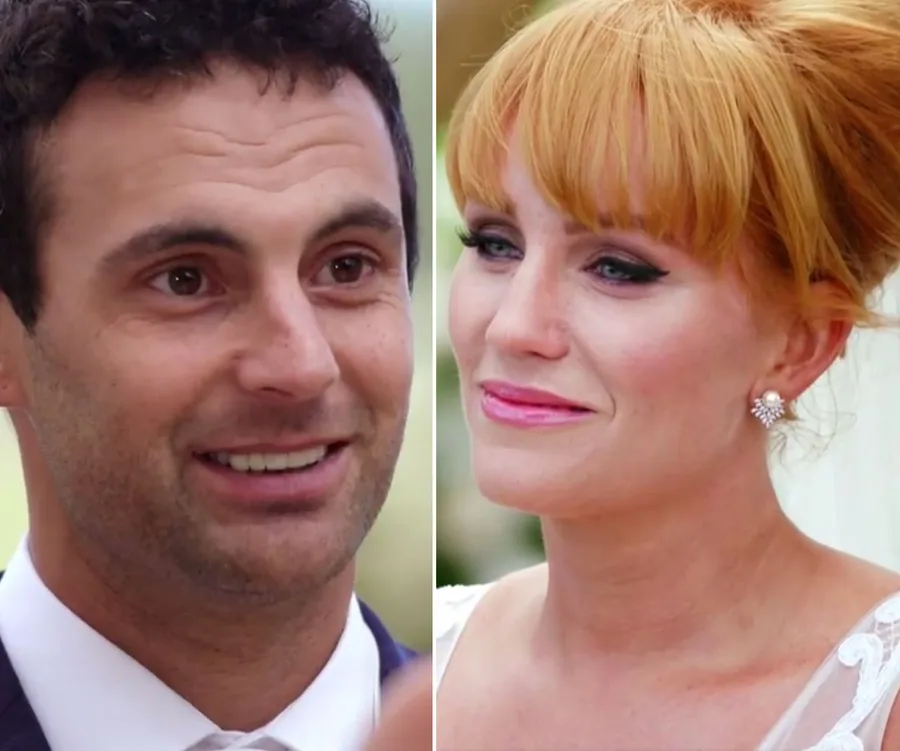 A couple from "Married at First Sight" share smiles and gaze at each other during a wedding scene.