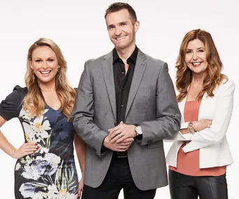 Three people smiling, two women and one man in professional attire, posing against a plain white background.