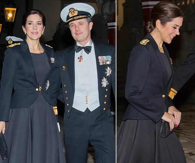 Couple in formal military attire; woman in navy dress and gold-embellished jacket, man in decorated naval uniform.
