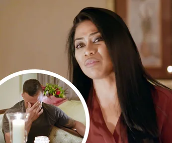 Woman speaking with an emotional expression, inset shows a man covering his face, setting is likely a dramatic scene.
