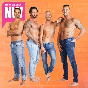 Shirtless men with tattoos in jeans posing against an orange brick wall, part of a magazine feature.