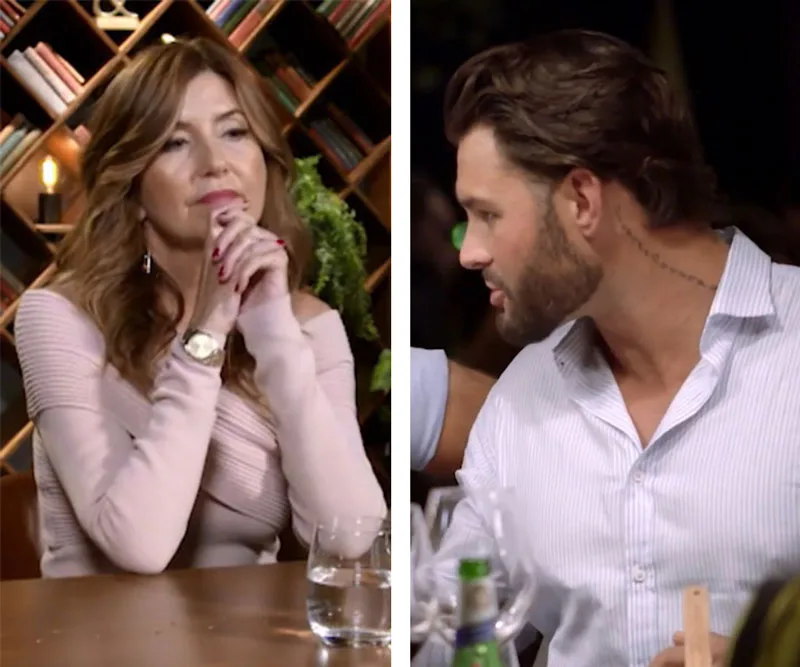 Two individuals from "Married at First Sight" sit at a table, engaged in a conversation.