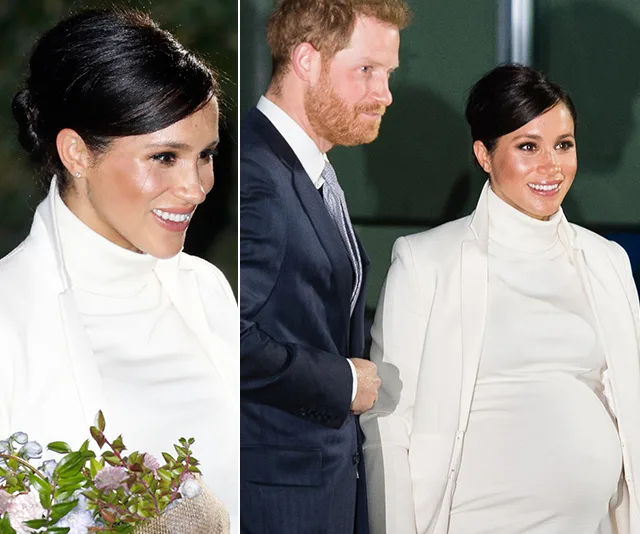 Meghan Markle in a white dress and coat, holding flowers, standing with a man in a suit.